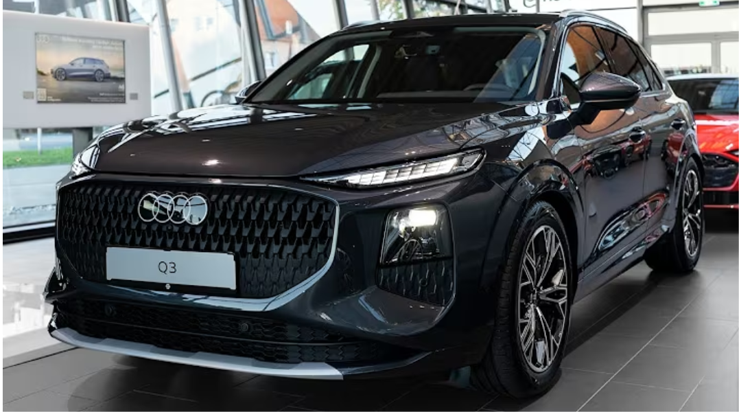 Front view of 2026 Audi Q3 top model showing large Singleframe grille, sharp LED headlights, and sporty bumper design